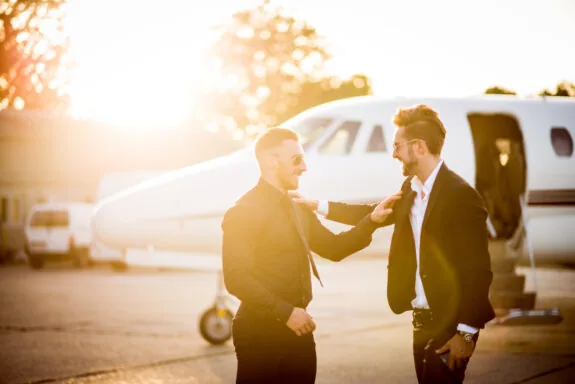Two businessmen meet at the airport.